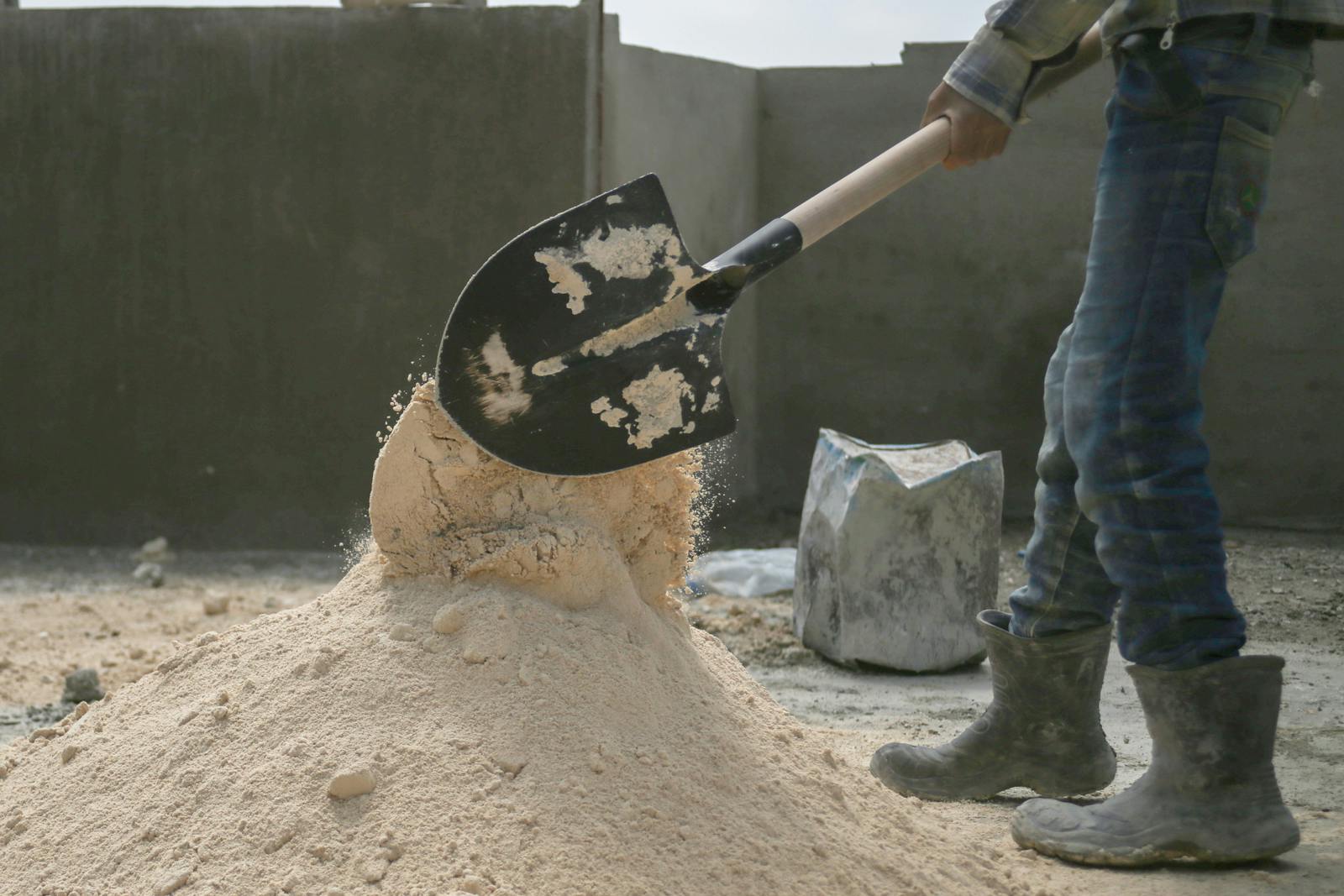 Man Working with Showel on Construction Site